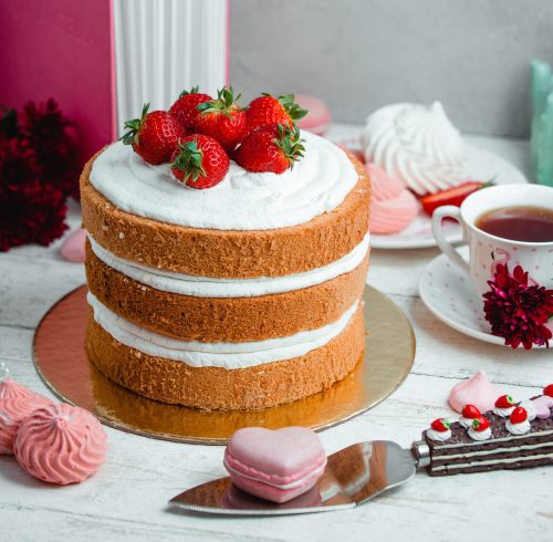 cake with whipped cream and strawberries